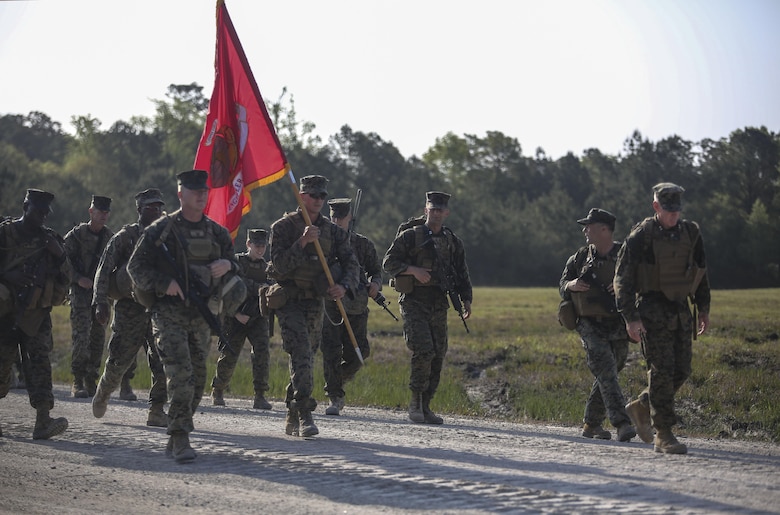 Maj. Gen. Brian D. Beaudreault, right, commanding general of 2nd Marine Division, Lt. Col. Gary McCullar, center left, commanding officer of 2nd Combat Engineer Battalion, and Sgt. Maj. Demetrius L. Hadley, left, the sergeant major of 2nd CEB, lead Marines and sailors with the battalion on a 12-mile hike to their new command post. The battalion had occupied their previous location in Hadnot Point since World War II. (U.S. Marine Corps photo by Cpl. Paul S. Martinez/Released)