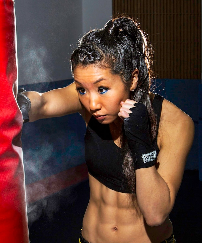 Air Force 1st Lt. Elizabeth Guidara, 12th Missile Squadron missile combat crew commander, hits a punching bag at the gym at Malmstrom Air Force Base, Mont., Dec. 19, 2015. Guidara is taking Marine Corps martial arts training to become a certified martial arts instructor. Air Force photo