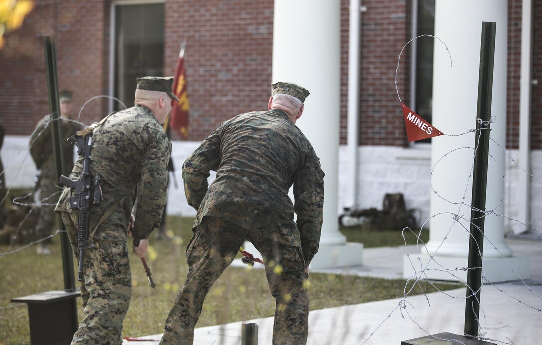 Major Gen. Brian Beaudreault, right, commanding general of 2nd Marine Division, and Lt. Col. Gary McCullar, the commanding officer of 2nd Combat Engineer Battalion, inaugurate the battalion’s relocation by cutting barbed wire at their new command post at Camp Lejeune, N.C., April 21, 2016. The battalion had occupied their previous location in Hadnot Point since World War II. (U.S. Marine Corps photo by Cpl. Paul S. Martinez/Released)