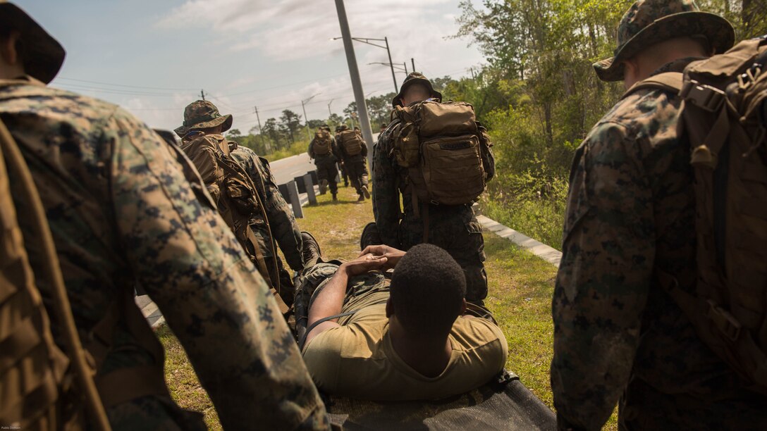 U.S. Marines with 2nd Battalion, 8th Marine Regiment transport a casualty to the landing zone during an attack evolution at Marine Corps Base Camp Lejeune, N.C., April 20, 2016. To add an extra element to the training, a Marine acted as a casualty during a patrol. Marines were then tasked to apply the proper steps and extract the casualty to the designated LZ. 