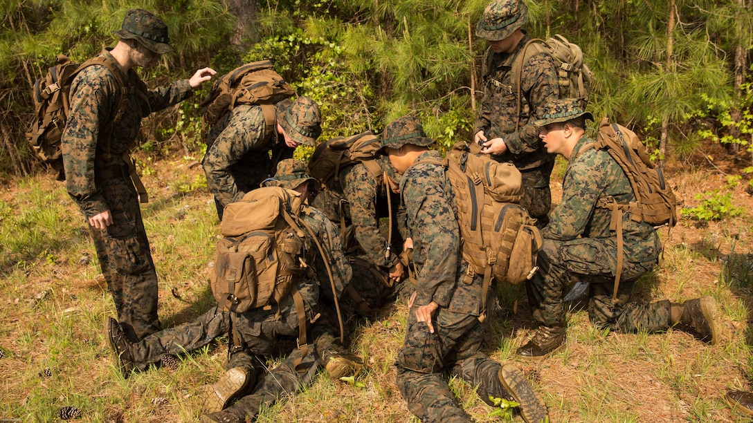 A Marine with 2nd Battalion, 8th Marine Regiment applies a tourniquet to a notional casualty during an attack evolution at Marine Corps Base Camp Lejeune, N.C., April 20, 2016. To add an extra element to the training, a Marine acted as a casualty during a patrol. Marines were then tasked to apply the proper steps and extract the casualty to the designated landing zone. 