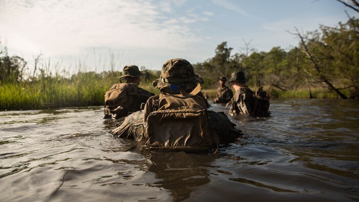 U.S. Marines with 2nd Battalion, 8th Marine Regiment swim their way around a trail that is known to have notional improvised explosive devices during an attack evolution at Marine Corps Base Camp Lejeune, N.C., April 20, 2016. Role players were placed throughout the course, adding various scenarios which included ambushing a patrol and assaulting an enemy fortified position. 