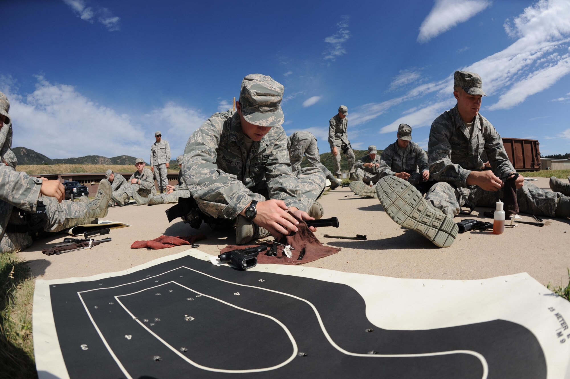 Cadets clean their weapons at the 10th Security Forces Squadron's Combat Arms training area. This fenced-off area in the U.S. Air Force Academy is marked with off-limits signs and is off-limits to anyone who is not attending official training. (U.S. Air Force photo/John Van Winkle)