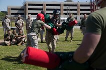 Marines with Headquarters and Service Battalion, U.S. Marine Corps Forces Command participate in a pugil stick bout during the Titan Challenge April 14 aboard Camp Allen, Norfolk, Virginia. The Titan Challenge was a four-part event which included an Obstacle course relay, pull-up/push-up ladder, tire flips, and a casualty evacuation race in which teams of four competed for 1st place. The Titan Challenge provided an opportunity for Marines and Sailors to practice unit cohesion and camaraderie outside of the normal work routine. (Photo by U.S. Marine Cpl. Jessika Braden/ Released)