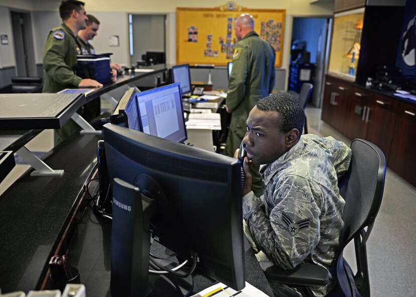 Senior Airman Markese Buckholtz, the 58th FS aviation resource manager, takes a call at Eglin Air Force Base, Fla., March 30, 2016. Throughout the morning, Buckholtz coordinates flights with pilots to begin the sorties for the F-35A Lightning II. (U.S. Air Force photo/Senior Airman Andrea Posey)