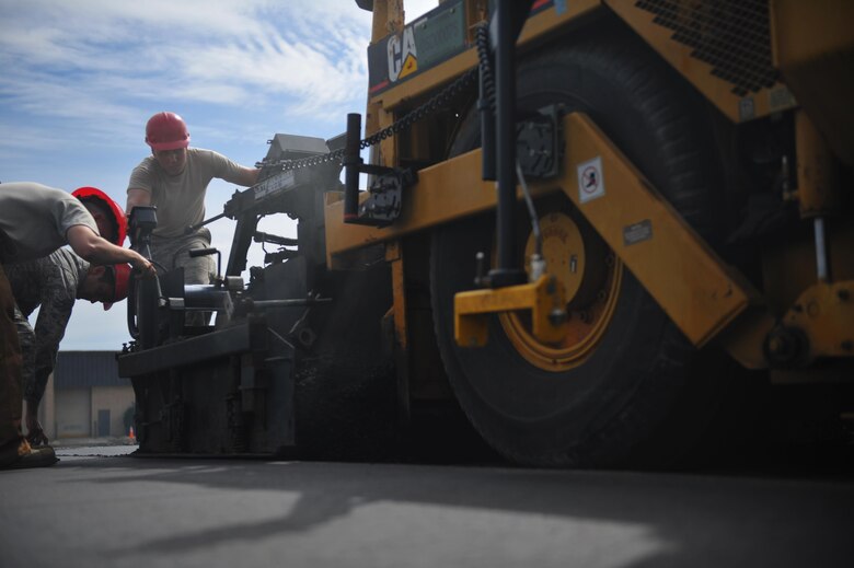 Senior Airman Andrew Hollibaugh, a heavy equipment operator with the 201st RED HORSE squadron, Fort Indiantown Gap, Pa., monitors the path of a paving machine at Hurlburt Field, Fla., April 20, 2016. The two-week milling and paving course repaired a parking lot and also served as a training opportunity. (U.S. Air Force photo by Airman 1st Class Joseph Pick)
