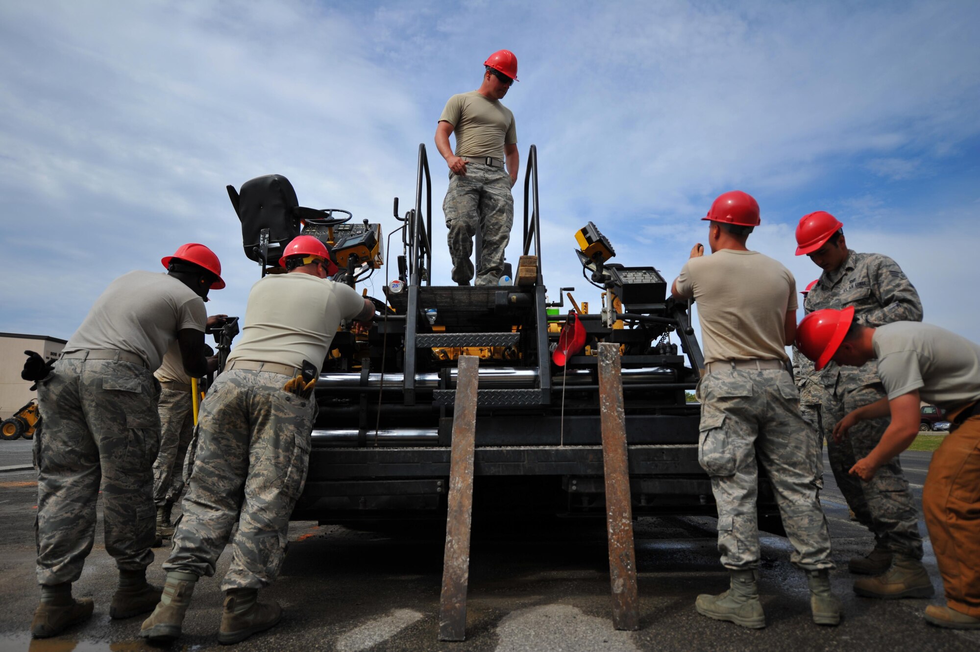 Airmen with various RED HORSE and Civil Engineering squadrons prepare to pave a parking lot on Hurlburt Field, Fla., April 20, 2016. As part of a two-week milling and paving training course, more than 20 Airmen from across the globe participated by laying asphalt to repair a parking lot. (U.S. Air Force photo by Airman 1st Class Joseph Pick)

