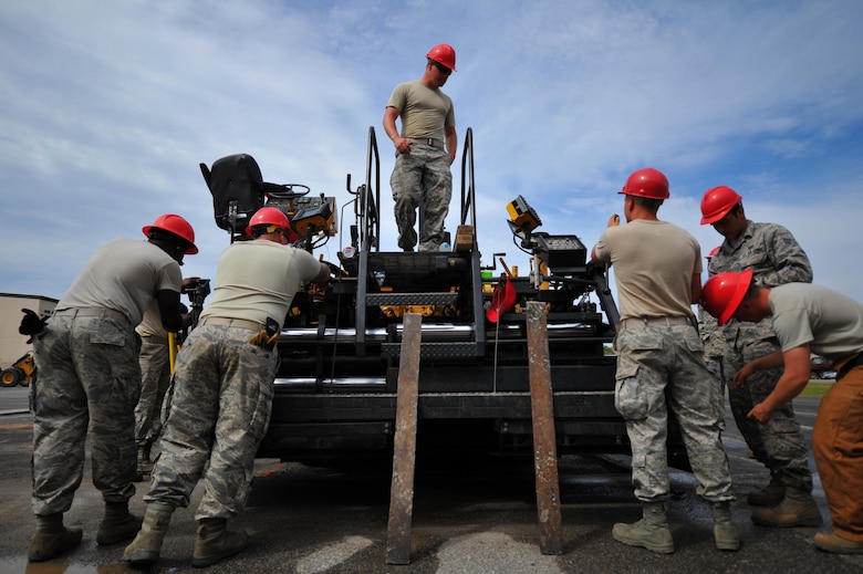 Airmen with various RED HORSE and Civil Engineering squadrons prepare to pave a parking lot on Hurlburt Field, Fla., April 20, 2016. As part of a two-week milling and paving training course, more than 20 Airmen from across the globe participated by laying asphalt to repair a parking lot. (U.S. Air Force photo by Airman 1st Class Joseph Pick)
