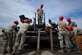 Airmen with various RED HORSE and Civil Engineering squadrons prepare to pave a parking lot on Hurlburt Field, Fla., April 20, 2016. As part of a two-week milling and paving training course, more than 20 Airmen from across the globe participated by laying asphalt to repair a parking lot. (U.S. Air Force photo by Airman 1st Class Joseph Pick)
