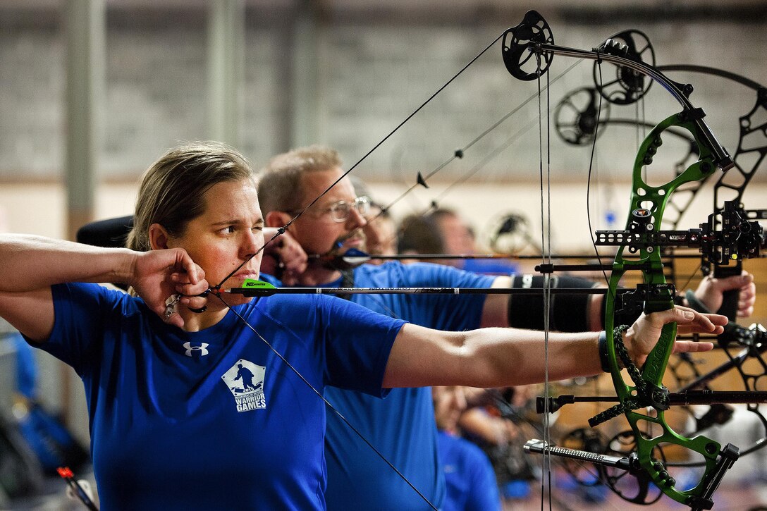 Kyle Burnett, a Warrior Games athlete, aims her bow during an afternoon archery training session at Eglin Air Force Base, Fla., April 6, 2016. Air Force photo by Samuel King Jr.