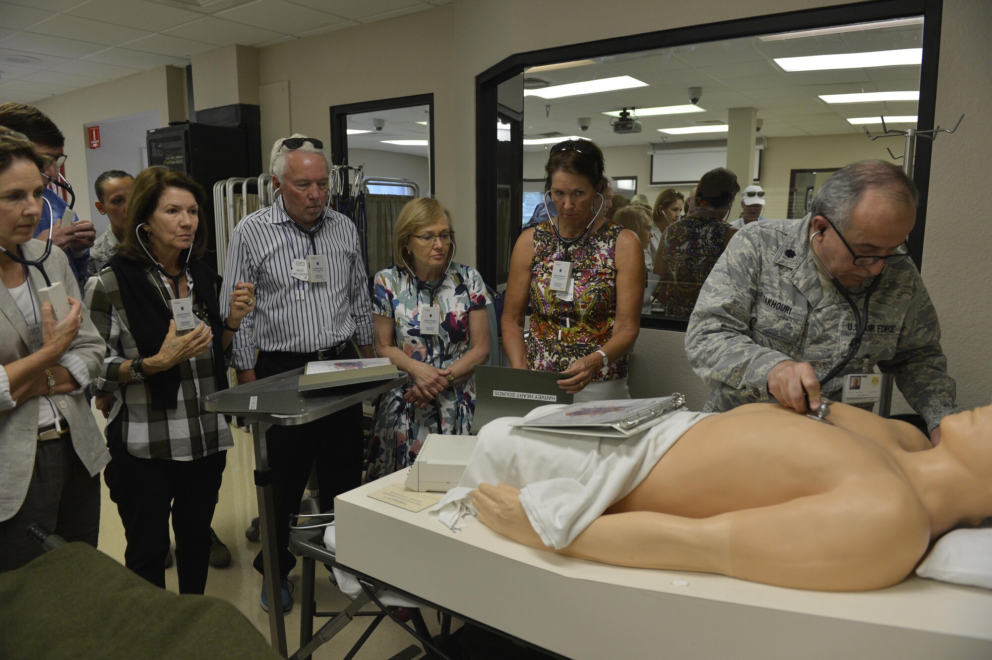 Members of the World President’s Group listen to different types of heartbeats through stethoscopes during a facilities tour April 21, 2016 at Luke Air Force Base, Ariz. The group, made up of civic leaders from the local community, was provided an opportunity to tour the base to learn more about Luke's mission. (U.S. Air Force photo by Senior Airman James Hensley)