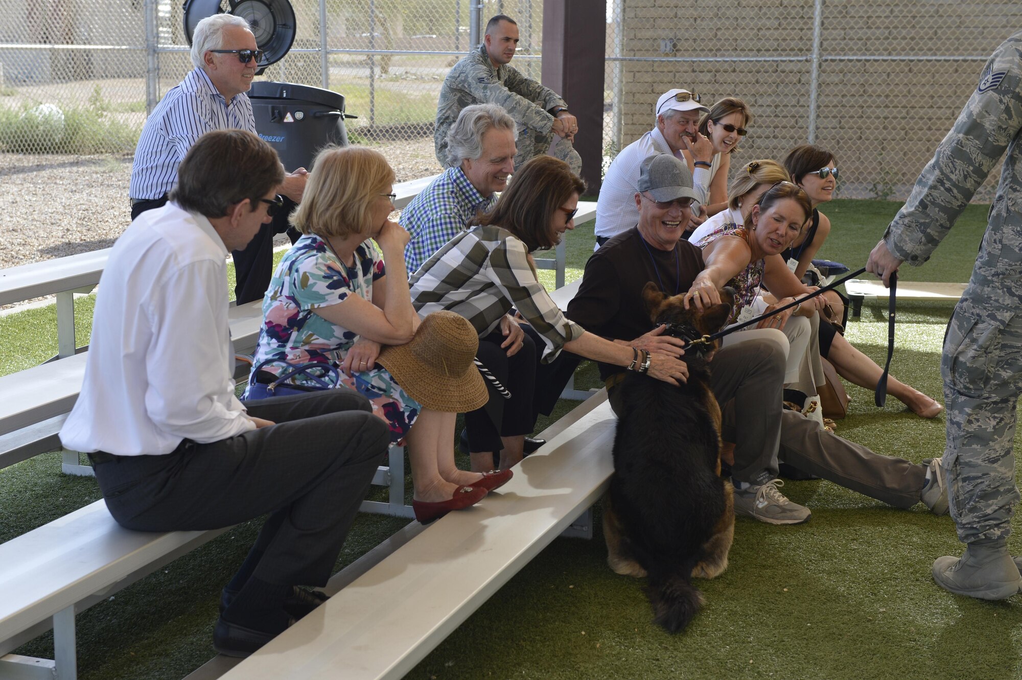 Members of the World President’s Group tour interact with Maxo, 56th Security Forces Squadron military working dog, April 21, 2016 at Luke Air Force Base, Ariz. The group was made up of civic leaders from the local community and toured the base to learn more about Luke's mission. (U.S. Air Force photo by Senior Airman James Hensley)