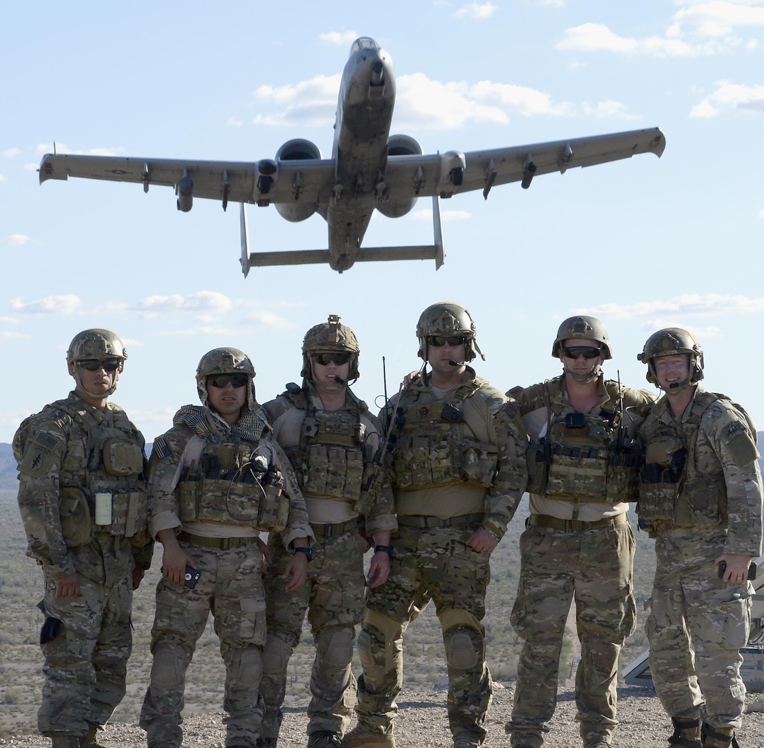 Tactical air control party members with the 147th Air Support Operations Squadron, 147th Reconnaissance Wing, pose as a 357th Fighter Squadron A-10 Warthog from Davis Monthan Air Force Base, Arizona, flies overhead April 12, 2016. The battlefield Airmen traveled to the desert range in Gila Bend for a weeklong simulated deployment with their Czech partners. 