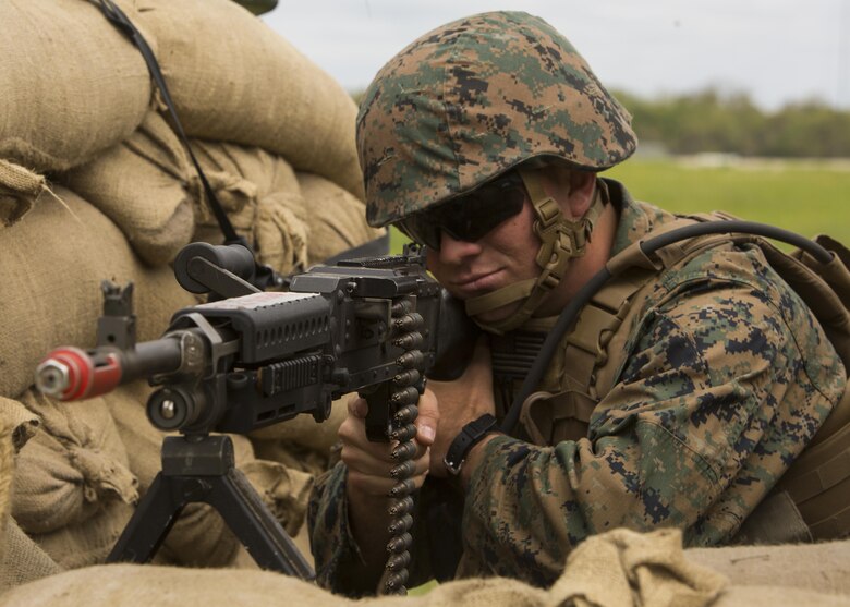 Pfc. Garrett Cone, a rifleman with 1st Platoon, Bravo Company, 2nd Law Enforcement Battalion, sights-in with the scope of his M240B machine gun while manning a security post during the II Marine Expeditionary Force Command Post Exercise 3 at Camp Lejeune, N.C., April 20, 2016. During the CPX, 2nd LEB posted security around the campsite and defended it from mock enemies, ensuring the headquarters element could complete the mission safely. (U.S. Marine Corps photo by Cpl. Michelle Reif/Released)