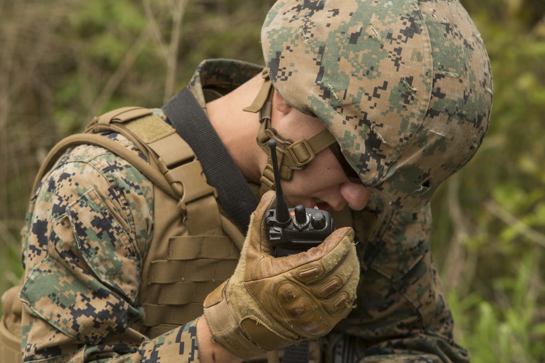 A fire team member with 1st Platoon, Bravo Company, 2nd Law Enforcement Battalion, calls in a report over the radio during a perimeter security patrol during the II Marine Expeditionary Force Command Post Exercise 3 at Camp Lejeune, N.C., April 20, 2016. During the CPX, 2nd LEB posted security around the campsite and defended it from mock enemies, ensuring the headquarters element could complete the mission safely. (U.S. Marine Corps photo by Cpl. Michelle Reif/Released)