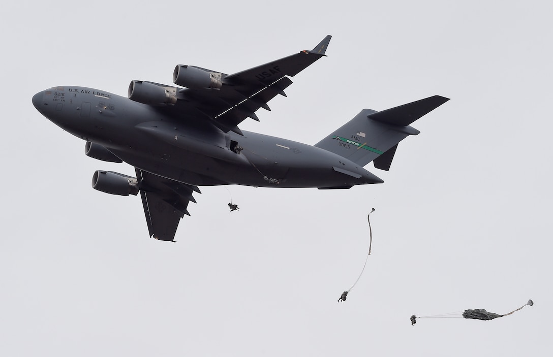 Paratroopers jump from an Air Force C-17 Globemaster III during a practice forced-entry parachute assault on Malemute drop zone at Joint Base Elmendorf-Richardson, Alaska, April 5, 2016. The paratroopers are assigned to the 25th Infantry Division, 4th Brigade Combat Team (Airborne). Air Force photo by Alejandro Pena