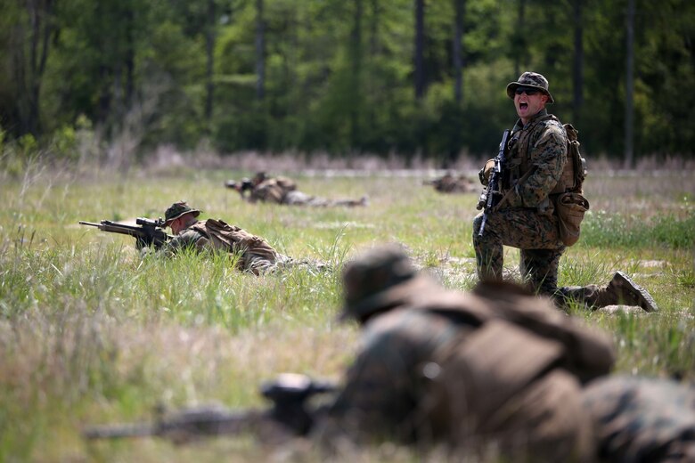 Marines with 3rd Battalion, 2nd Marine Regiment receive commands while holding their positions during a training exercise at Camp Lejeune, N.C., April 20, 2016. The unit practiced buddy rushing and squad tactics to maintain readiness and prepare for future deployments. (U.S. Marine Corps photo by Lance Cpl. Brianna Gaudi/Released)
