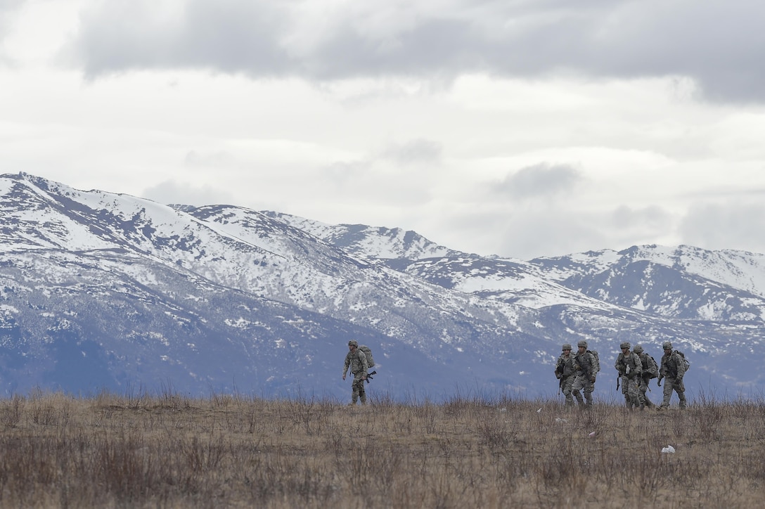 Paratroopers proceed to a rally point during a practice forced-entry parachute assault on Malemute drop zone at Joint Base Elmendorf-Richardson, Alaska, April 5, 2016. Air Force photo by Alejandro Pena