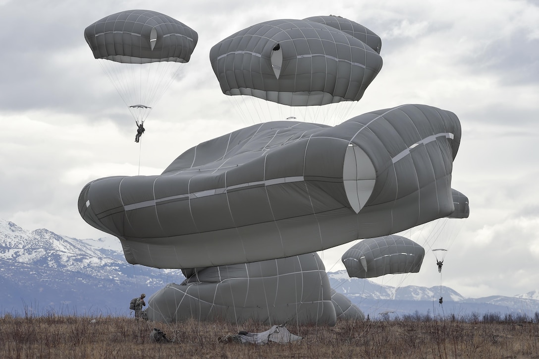 Paratroopers land during a practice forced-entry parachute assault on Malemute drop zone at Joint Base Elmendorf-Richardson, Alaska, April 5, 2016. Air Force photo by Alejandro Pena
