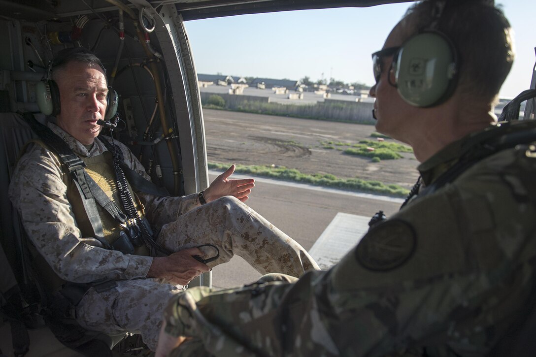 Marine Corps Gen. Joe Dunford, chairman of the Joint Chiefs of Staff, left, speaks to Army Lt. Gen. Sean McFarland, commander, Combined Joint Task Force - Operation Inherent Resolve, during a helicopter transit to Baghdad, April 21, 2016. DoD photo by Navy Petty Officer 2nd Class Dominique A. Pineiro