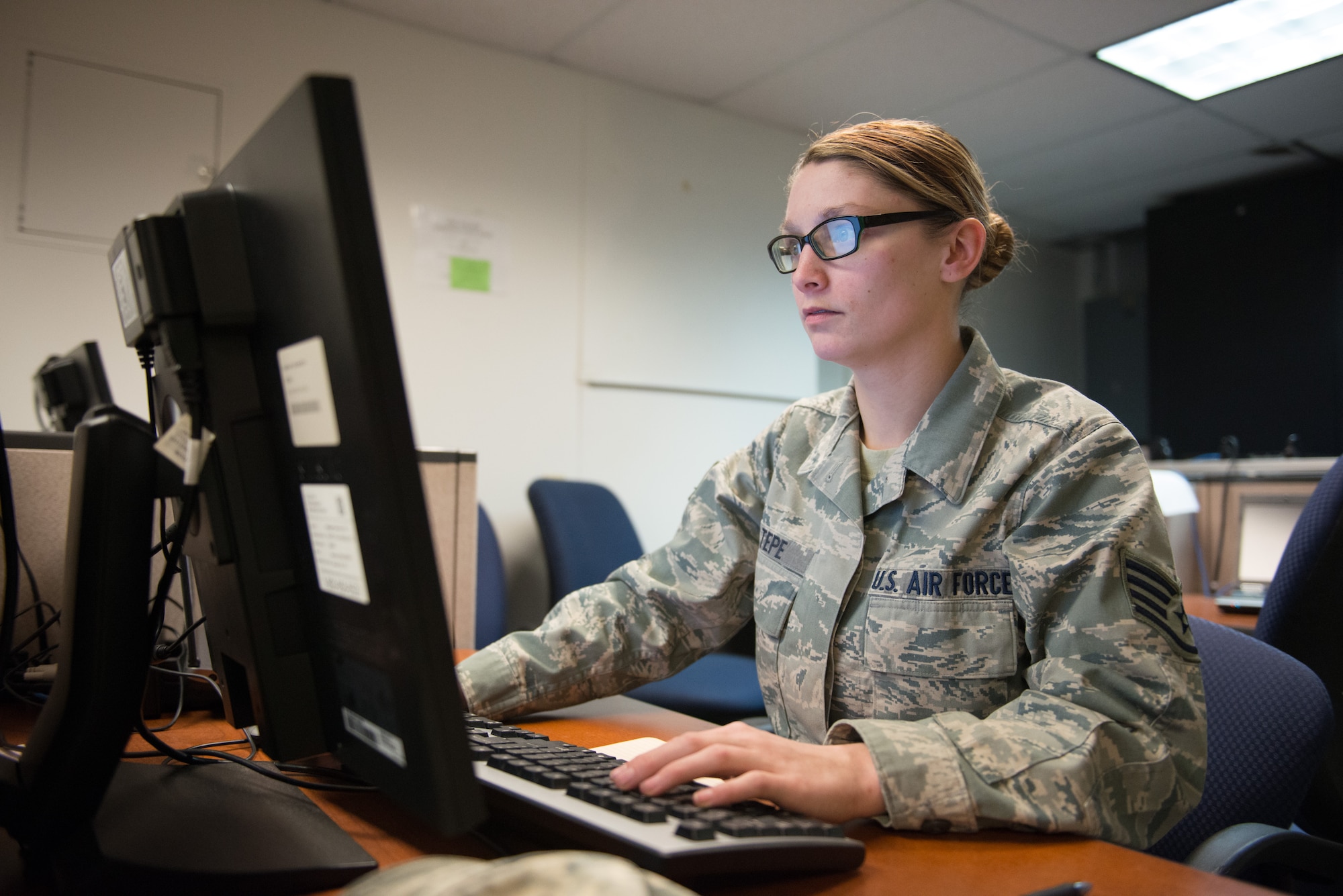 Staff Sgt. Brandi Tepe, a load planner at the 27th Aerial Port Squadron, prepares documents for the humanitarian cargo shipment to Afghanistan March 5. (U.S. Air Force Photo by Staff Sgt. Trevor Saylor)