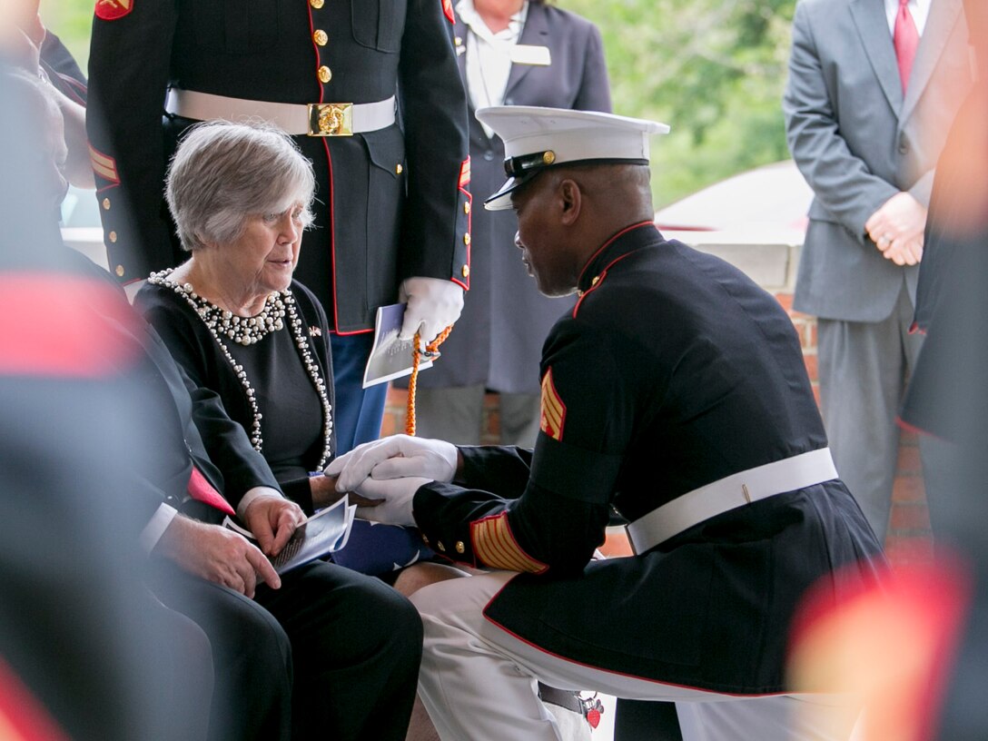 Master Gunnery Sgt. Leonard Spain, funeral director, Marine Barracks Washington, D.C., presents the casing from a three shot volley, to Mrs. Cafferata during the funeral service of her husband, Medal of Honor Recipient, Pfc. Hector A. Cafferata Jr. (USMCR), at Quantico National Cemetery, Va., April 22, 2016. According to Cafferata’s Medal of Honor award citation, on Nov. 28, 1950 while serving as a rifleman with Fox Company, 2nd Battalion, 7th Marines, 1st Marine Division, during the Chosin Reservoir Campaign, Cafferata’s fortitude, great personal valor, and dauntless perseverance in the face of almost certain death, saved the lives of several of his fellow Marines and contributed essentially to the success achieved by his company in maintaining its defensive position against tremendous odds. Cafferata passed away, April 12, 2016 at the age of 86. (Official Marine Corps photo by Cpl. Chi Nguyen/Released)