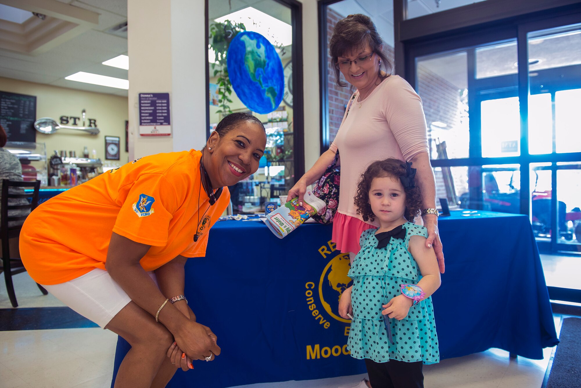 Lytana Fowler, wife of William Fowler, 23d Civil Engineer Squadron chief of environmental compliance, left, poses with Marie and Hailey Echols, family members of U.S. Air Force 1st Lt. Jordan Echols, 76th Fighter Squadron, during an Earth Day event, April 22, 2016, at Moody Air Force Base, Ga. Moody’s Earth Day volunteers gave out educational resources to increase awareness on the importance of environmental protection. (U.S. Air Force photo by Airman 1st Class Greg Nash/Released)