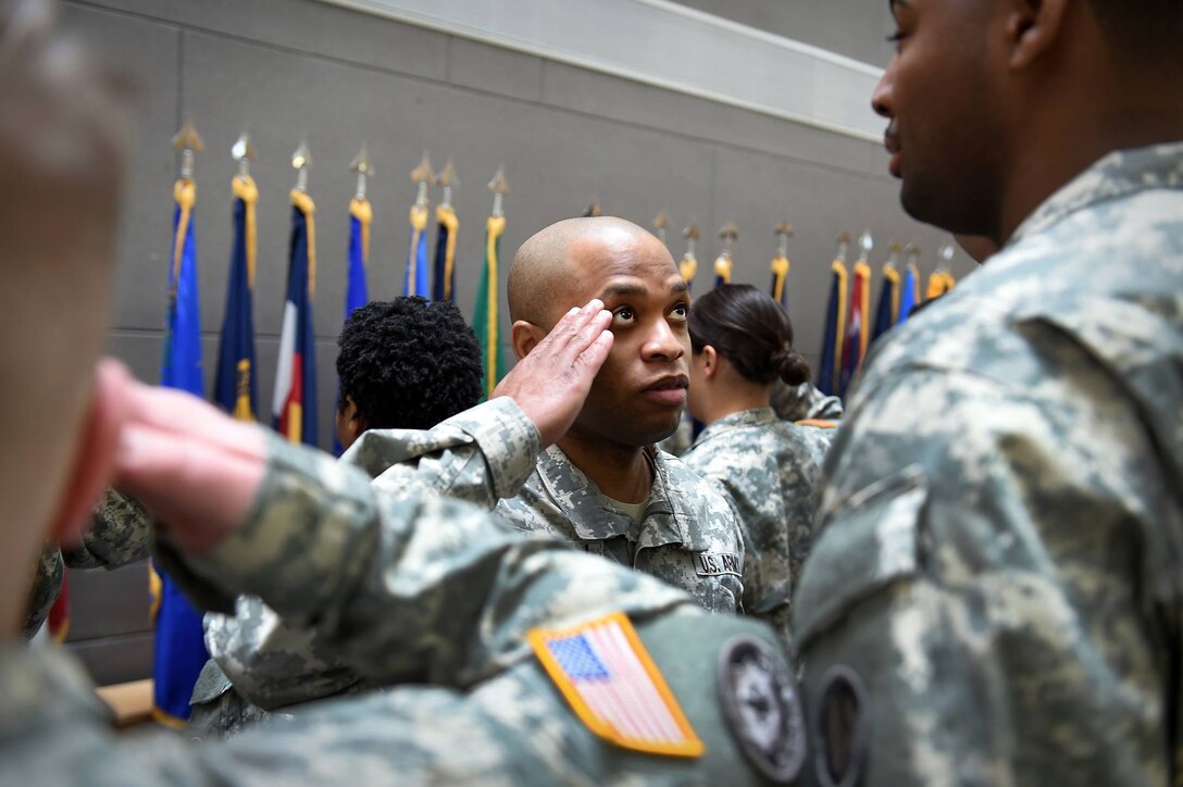 Master Sgt. Laroy Warren, Human Resources Sergeant, G1, demonstrates a proper salute to junior soldiers in formation. The command staff conducted drill and ceremony rehearsals to prepare them for Basic Leaders Course.
(Photo by Sgt. Aaron Berogan)