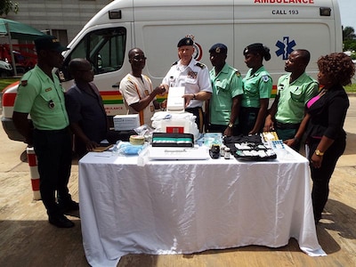 Maj. Mark McEvers, bilateral affairs officer for the North Dakota National Guard, center, assists with the delivery of $7,300 in medical supplies to representatives of the Ghanaian National Ambulance Service located at the 37th Military Hospital and Noguchi Memorial Institute for Medical Research in Accra, Ghana.