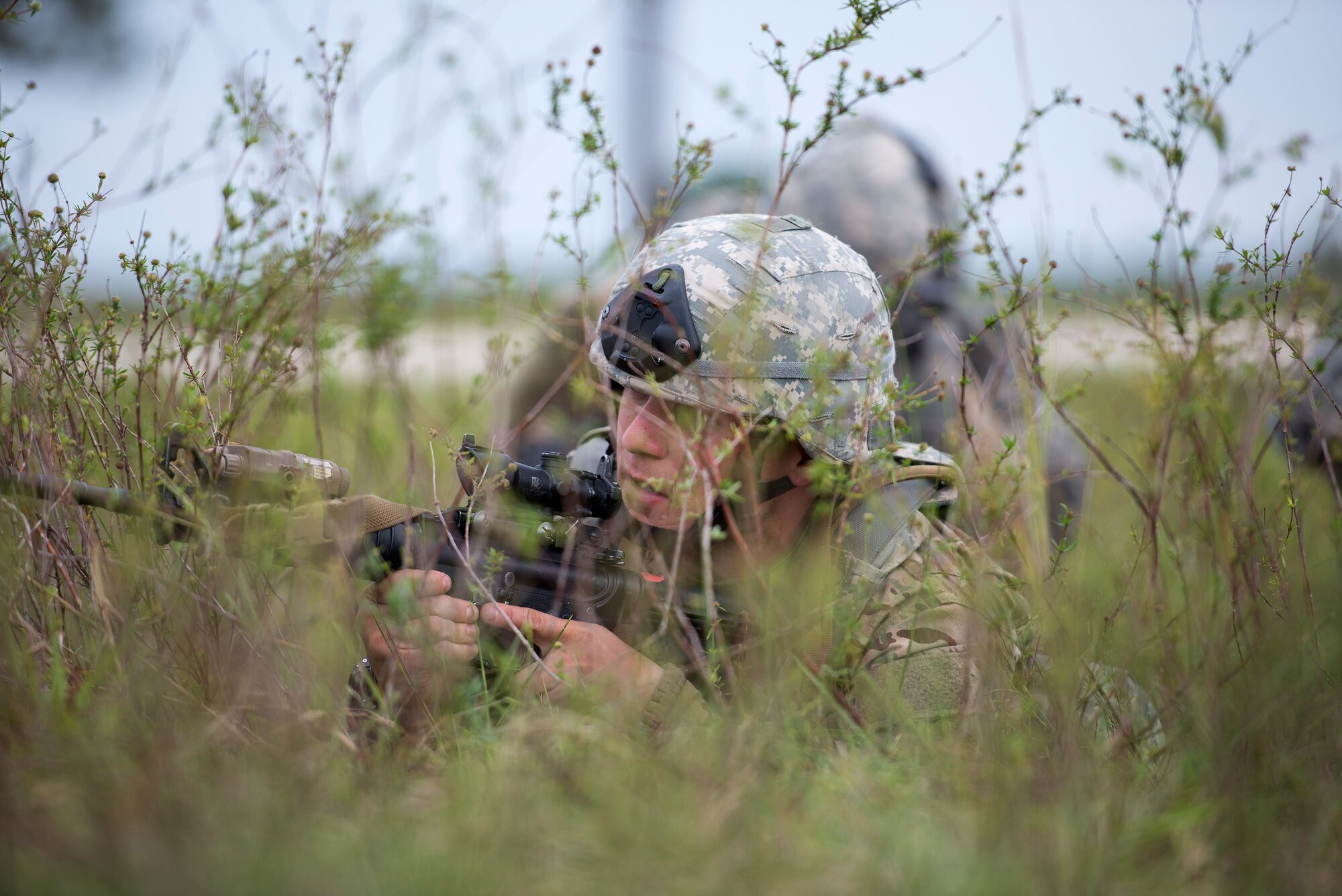U.S. Air Force Tech Sgt. Brian Marshall, 823d Base Defense Squadron NCO in charge of training, provides cover for his team during a care under fire scenario, April 13, 2016, at Avon Park Air Force Range, Fla. Airmen had to rescue a simulated causality, provide self-aid buddy care, and get the causality to safety. (U.S. Air Force photo by Airman 1st Class Janiqua P. Robinson/Released)