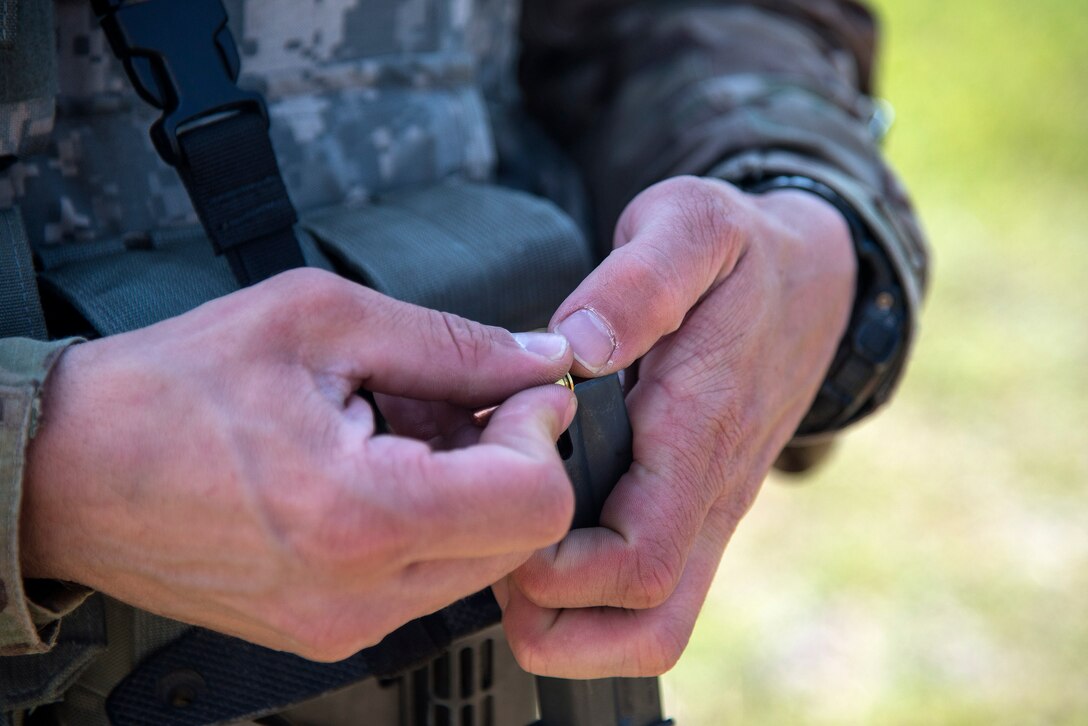 U.S. Air Force Staff Sgt. James Jackson, 823d Base Defense Squadron support NCO in charge, loads a magazine with ammunition April 13, 2016, at Avon Park Air Force Range, Fla. Spartan Warrior week at is an annual combat readiness exercise hosted by the 93d Air Ground Operation Wing, which brings together battlefield Airmen from 20 geographically separated units. (U.S. Air Force photo by Airman 1st Class Janiqua P. Robinson/Released)