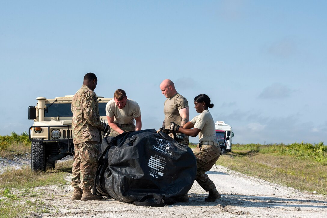 U.S. Air Force Airmen from the 823d Base Defense Squadron pack up a tent April 14, 2016, at Avon Park Air Force Range, Fla. Teams had to put up a tent in under 15 minutes to pass the challenge. (U.S. Air Force photo by Airman 1st Class Janiqua P. Robinson/Released)