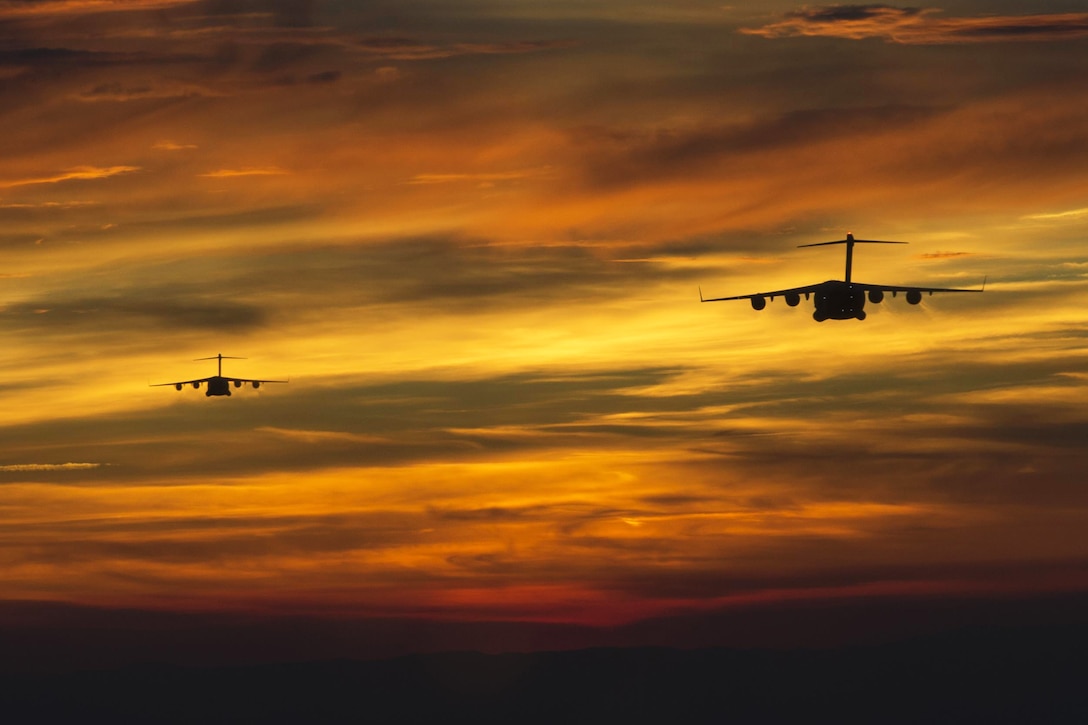 Two C-17 Globemaster IIIs from the 437th Airlift Wing prepare to drop soldiers from the 82nd Airborne Division during a mass tactical exercise at Fort Bragg, N.C., April 15, 2016. Air Force photo by Senior Airman Taylor Queen
