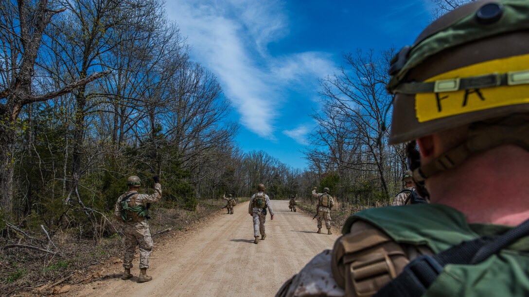 Students at the new Marine Military Police Officer Basic Course pass down a command while on patrol during a field exercise at Fort Leonard Wood, Missouri, April 14, 2016. Marines in this course learn how to properly lead their Marines before they go to the fleet. 