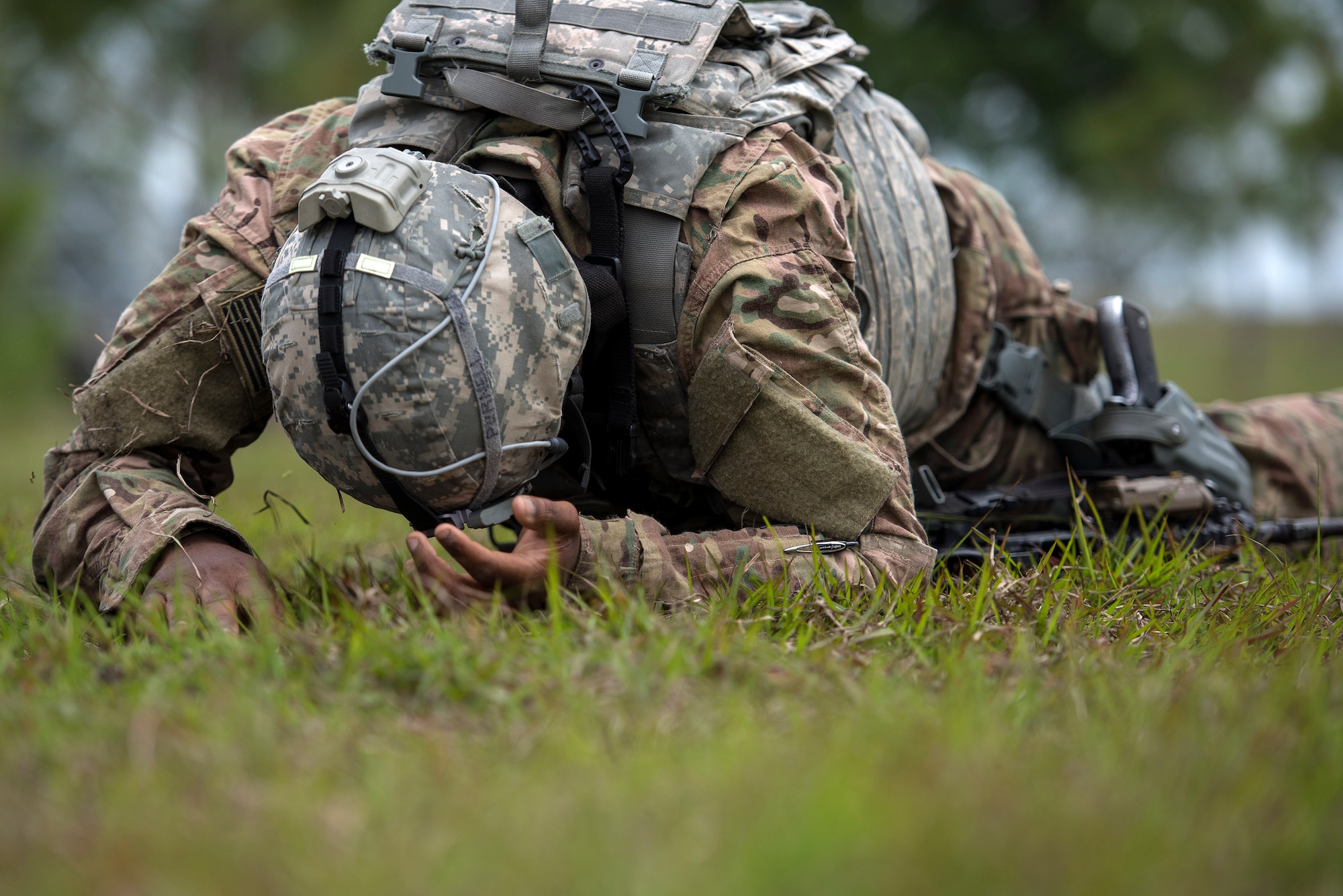 U.S. Air Force Senior Airman Eric Purnell, 823d Base Defense Squadron fireteam member, low crawls during an obstacle course, April 13, 2016, at Avon Park Air Force Range, Fla. Spartan Warrior week allowed Airmen assigned to various squadrons across the U.S. to split into teams of four and compete in generalized and career based challenges. (U.S. Air Force photo by Airman 1st Class Janiqua P. Robinson/Released)