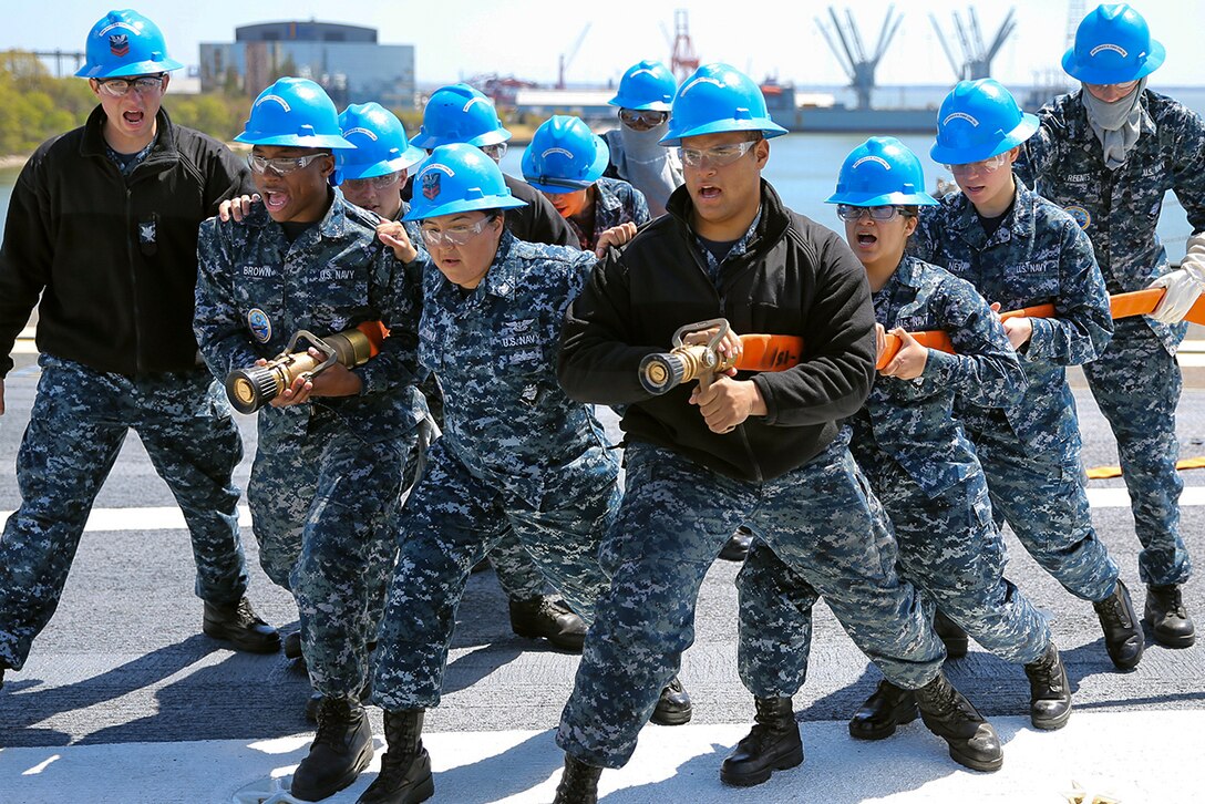 Sailors practice firefighting techniques during a drill on the flight deck of the aircraft carrier Pre-Commissioning Unit Gerald R. Ford in Newport News, Va., April 14, 2016. The drill, which focused on damage control and emergency responses, is a significant step in certifying the crew as they train to take delivery of the ship. Navy photo by Seaman Apprentice Connor Loessin