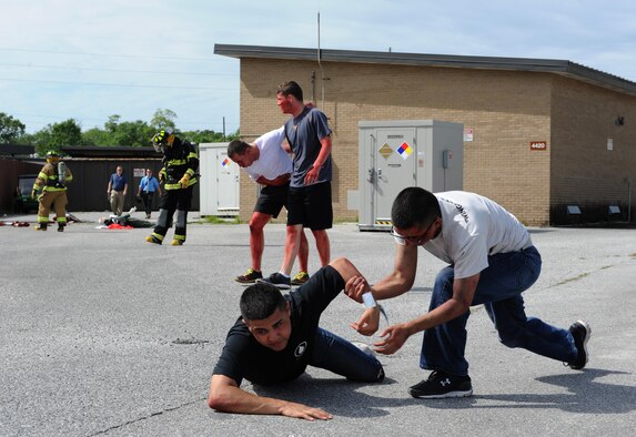 Airman Alex Rothrock and Airman 1st Class David DeLeon, 336th Training Squadron students, portray “victims” during a Chemical, Biological, Radiological, Nuclear and Explosive exercise scenario, April 21, 2016, Keesler Air Force Base, Miss. The Force Protection Condition exercise scenario simulated an intruder entering the hazardous waste 90-day accumulation site, where an explosion occurred causing a mass casualty event. The exercise tested the base’s capability to react to and recover from a mass casualty event. (U.S. Air Force photo by Kemberly Groue)