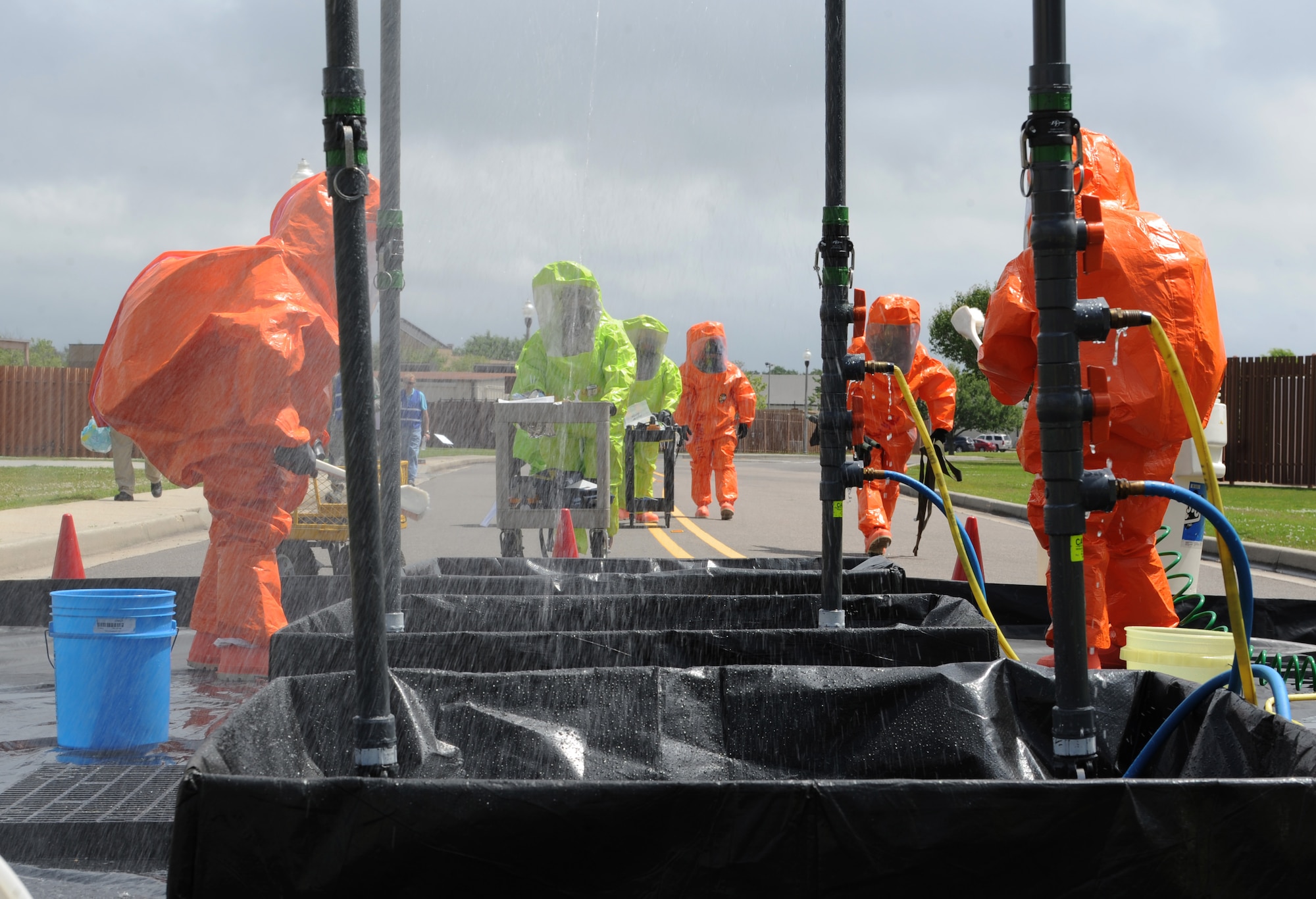 81st Aerospace Medicine Squadron bioenvironmental engineering technicians and 81st Infrastructure Division firefighters approach the decontamination site during a Chemical, Biological, Radiological, Nuclear and Explosive exercise scenario, April 21, 2016, Keesler Air Force Base, Miss. The Force Protection Condition exercise scenario simulated an intruder entering the hazardous waste 90-day accumulation site, where an explosion occurred causing a mass casualty event. The exercise tested the base’s capability to react to and recover from a mass casualty event. (U.S. Air Force photo by Kemberly Groue)