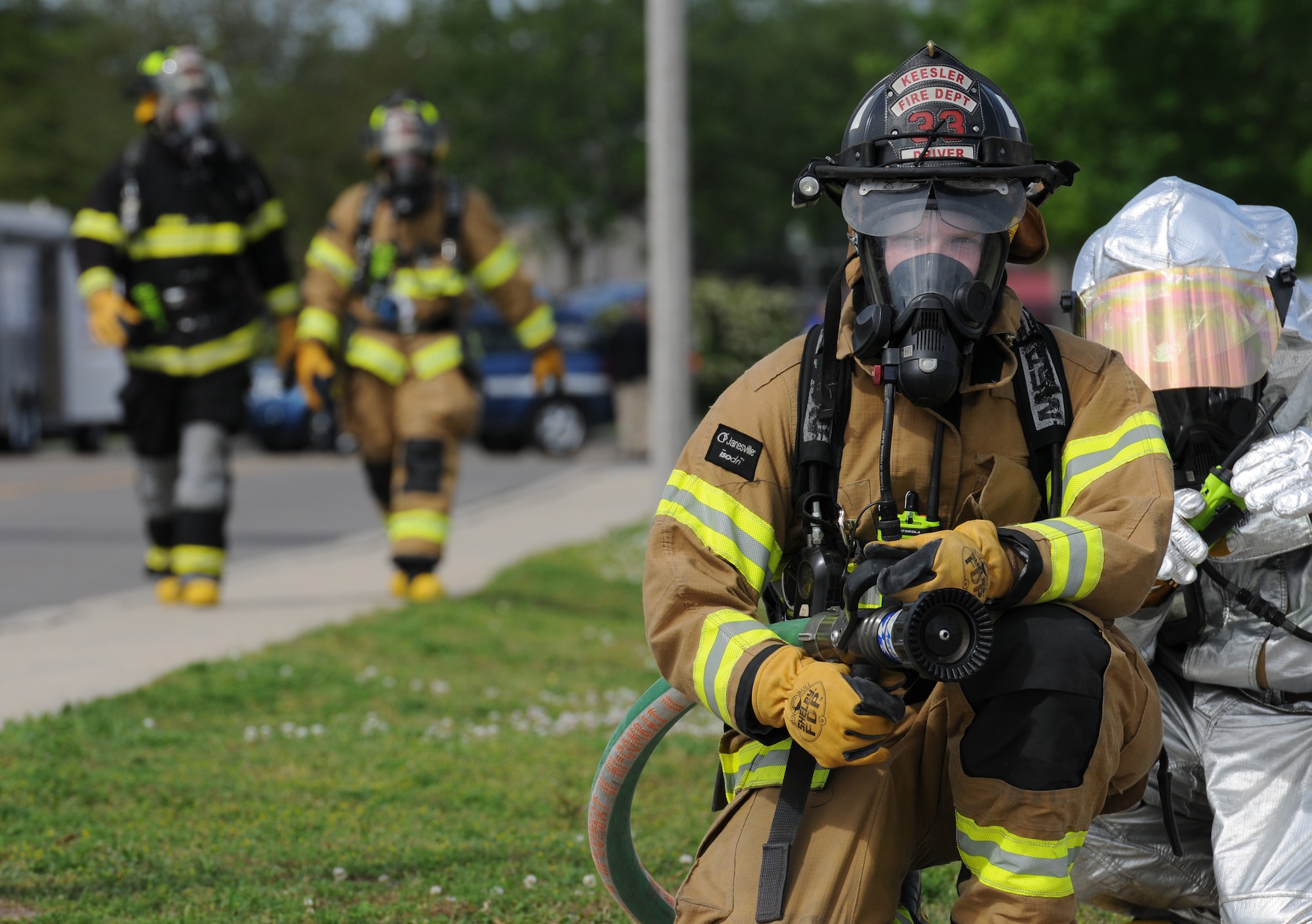 Senior Airman Codee Potts, 81st Infrastructure Division firefighter, prepares to use a fire hose during a Chemical, Biological, Radiological, Nuclear and Explosive exercise scenario, April 21, 2016, Keesler Air Force Base, Miss. The Force Protection Condition exercise scenario simulated an intruder entering the hazardous waste 90-day accumulation site, where an explosion occurred causing a mass casualty event. The exercise tested the base’s capability to react to and recover from a mass casualty event. (U.S. Air Force photo by Kemberly Groue)