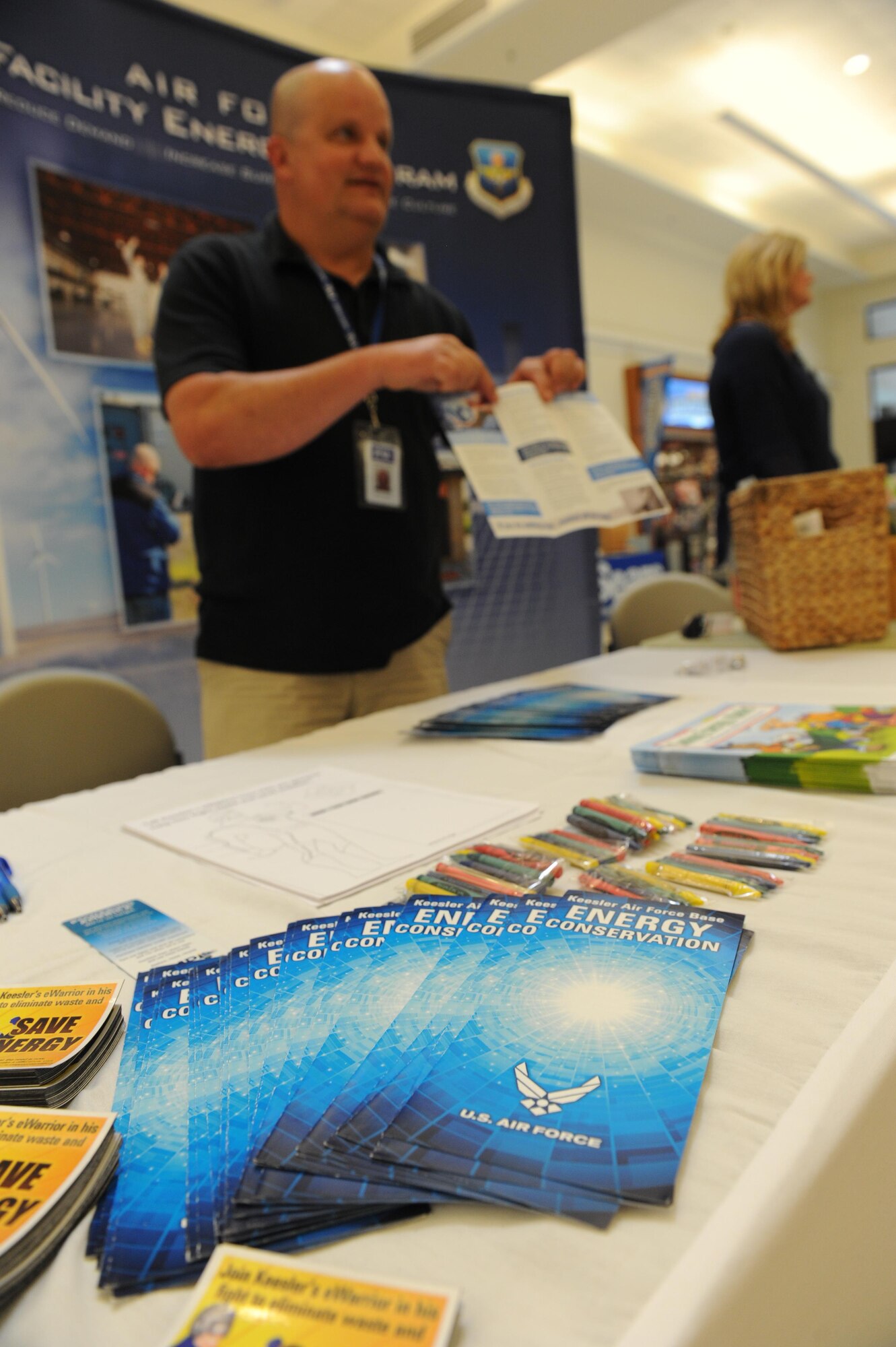 Bruce Groves, Base Operations Support energy manager, passes out informational recycling pamphlets at the base exchange April 22, 2016, Keesler Air Force Base, Miss.  The Base Operations Support energy program and environmental office set up a booth with hand-outs and literature materials about recycling and environmental sustainability for Keesler personnel in recognition of Earth Day. Recycling bins, decorated by the children from the child development center, were also on display. (U.S. Air Force photo by Kemberly Groue)