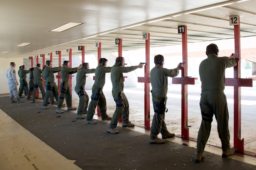 Aircrew members from the 70th Air Refueling Squadron, 79th ARS, 301st Airlift Squadron and the 312th AS fire M9 weapons during an M9 qualification class at the 349th Security Forces Squadron Combat Arms Training range on Apr. 17, 2016 at Travis Air Force Base, Calif. The qualification is a general requirement for aircrew members and is also a required qualification for deploying.  (U.S. Air Force photo/Airman 1st Class Shelby R. Horn)