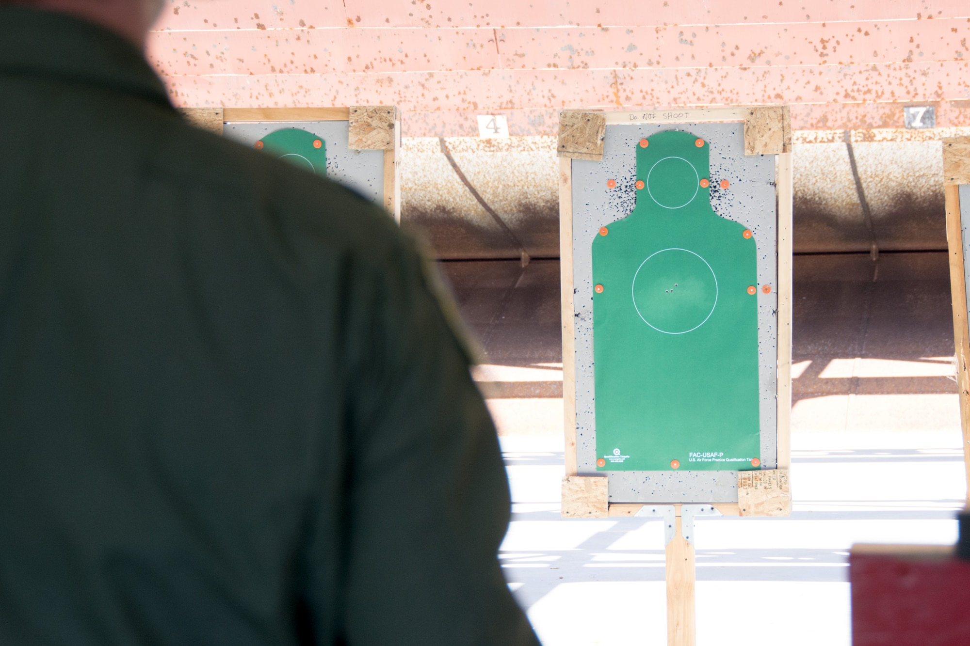 An airman looks on at his target during an M9 qualifications course at the 349th Security Forces Squadron Combat Arms Training range on Apr. 17, 2016 at Travis Air Force Base, Calif. During the course airmen rotate between head and chest targets, aiming to keep all shots within the white circle. (U.S. Air Force photo/Airman 1st Class Shelby R. Horn)
