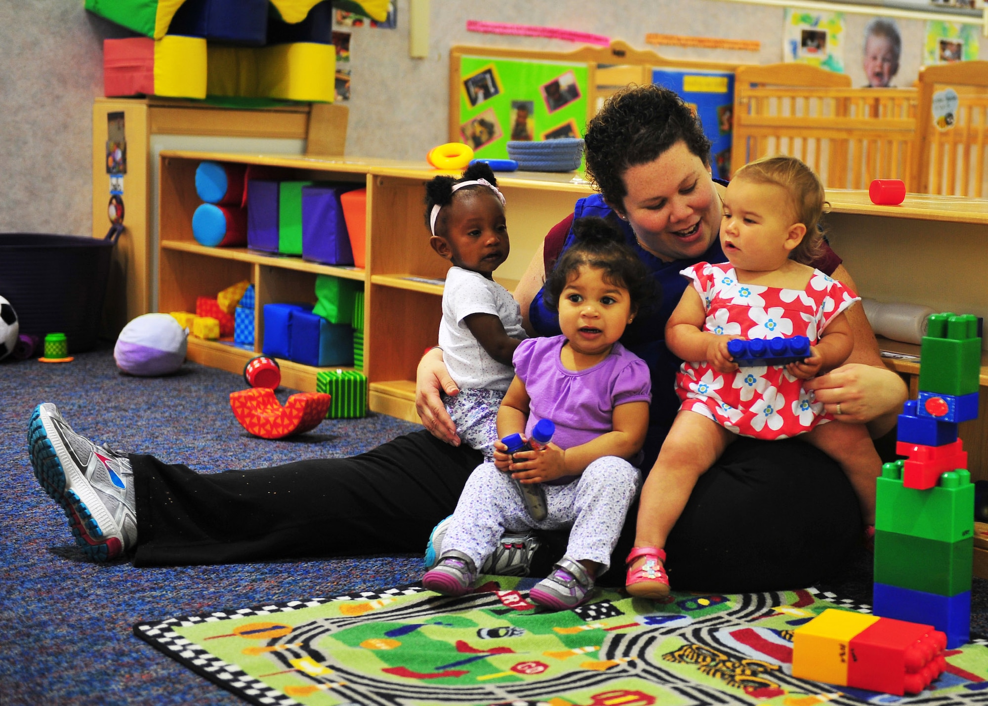 Katlin Cram, 325th Force Support Squadron Child Development Center caretaker, interacts with three of the children in the facility April 13, at the CDC. The Child Development Center is part of the Airman and Family Services Flight which also covers three other programs; the Airman and Family Readiness Center, Youth Programs and Family Child Care. The CDC is charged with taking care of children belonging to Team Tyndall members during the day. (U.S. Air Force photo by Senior Airman Dustin Mullen/Released)
