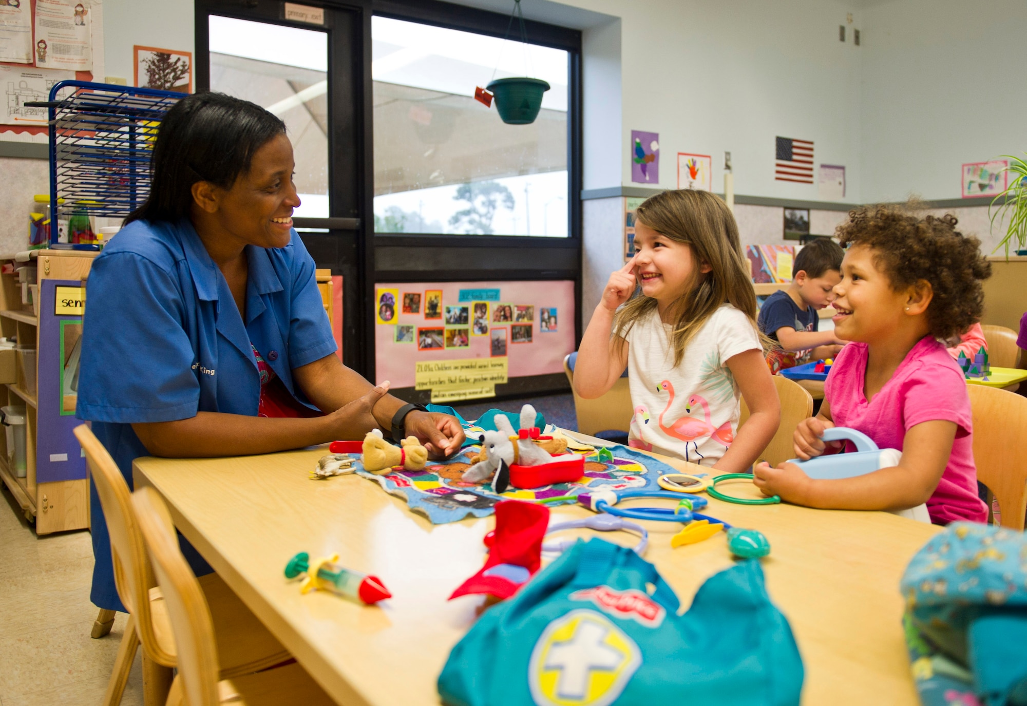 Deidre King, 325th Force Support Squadron Child Development Center caretaker, interacts with two of the children in the facility April 13, at the CDC. The CDC is charged with taking care of children belonging to members of Team Tyndall during the day. The facility maintains high expectations of its employees, providing them training consistent with current Air Force standards.  (U.S. Air Force photo by Senior Airman Dustin Mullen/Released)