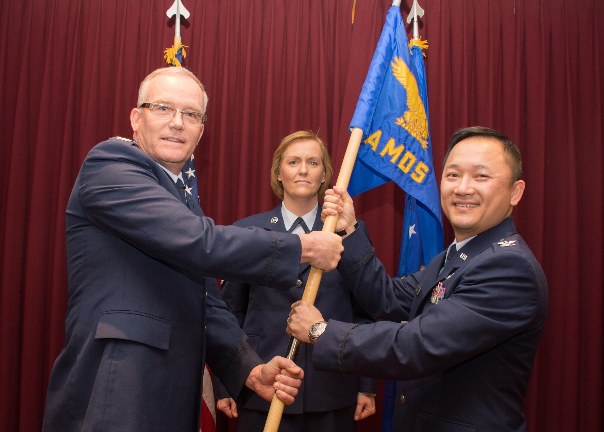 Col. Minh-Tri Trinh assumes command of the 349th Aerospace Medicine Squadron from Col. Kurt Lambert, 349th Medical Group commander, during a ceremony April 2, 2016, at Travis Air Force Base, Calif. Prior to assuming commander, Trinh served as the 349th AMDS chief of administrative services. (U.S. Air Force photo/Senior Master Sgt. Rachel Martinez)