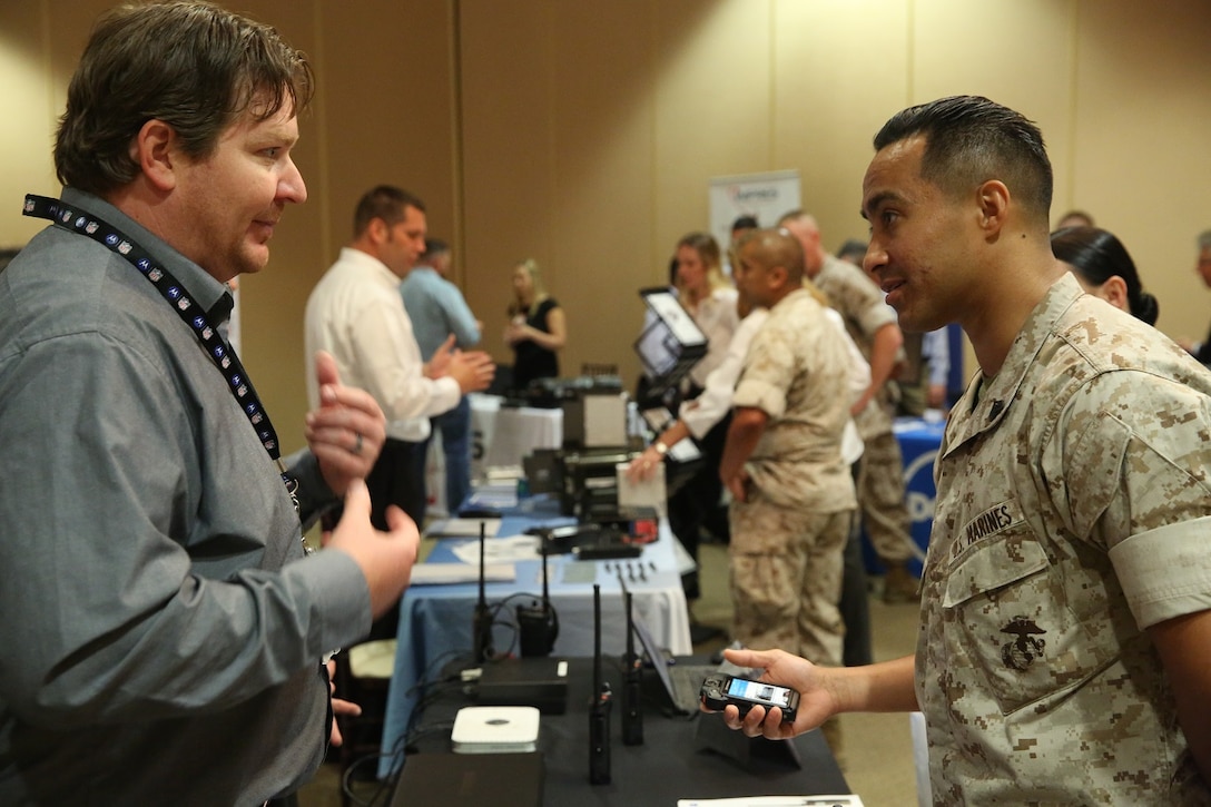 MARINE CORPS BASE CAMP PENDLETON, Calif. – Sgt. Jesus Maldonado engages in conversation about radio equipment at the Pacific Views Events Center during the “Tactical & Technology Day” on Camp Pendleton April 20, 2016. This exhibition gives Marines an opportunity to present feedback to companies about their experience with equipment produced by the each organization. Maldonado is a training chief with the Comptroller’s office, 1st Marine Division, and is a Perth Amboy, N.J. native. (U.S. Marine Corps photo by Lance Cpl. Shellie Hall/ Not Released)