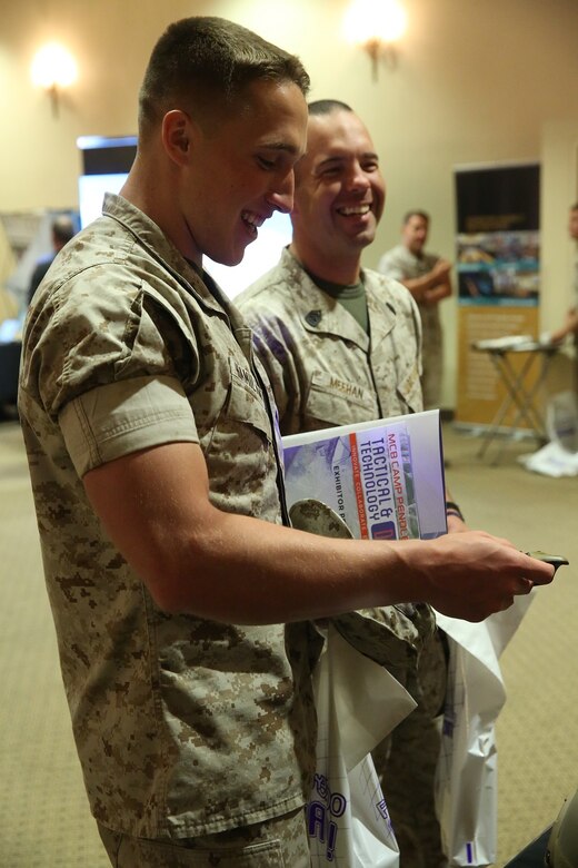 MARINE CORPS BASE CAMP PENDLETON, Calif. – Sgt. Ryan Hamilton and Gunnery Sgt. William Meehan, right, handle night vision equipment at the Pacific Views Events Center during the “Tactical & Technology Day” on Camp Pendleton April 20, 2016. This event showcases the latest technology and training opportunities for Marines. Meehan is the satellite communications staff non-commissioned officer in charge with Marine Corps Technical Systems Support Activity and is a Woburn, Mass. native. Hamilton is a digital wide-band repairman with Marine Corps Technical Systems Support Activity and is a Clear Lake, Wash. native. (U.S. Marine Corps photo by Lance Cpl. Shellie Hall/ Not Released)