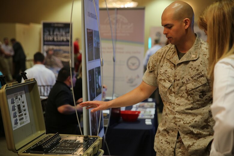 MARINE CORPS BASE CAMP PENDLETON, Calif. - 1st Lt. Carl Welch inquires about the Ground Renewable Expeditionary Energy Network System at the Pacific Views Events Center during the “Tactical & Technology Day” on Camp Pendleton April 20, 2016. The system collects solar energy and converts it into useable energy. Welch is a communications officer with 3rd Low Altitude Air Defense Battalion, 3rd Marine Aircraft Wing, and is a Port Orchard, Wash. native. (U.S. Marine Corps photo by Lance Cpl. Shellie Hall/ Not Released)