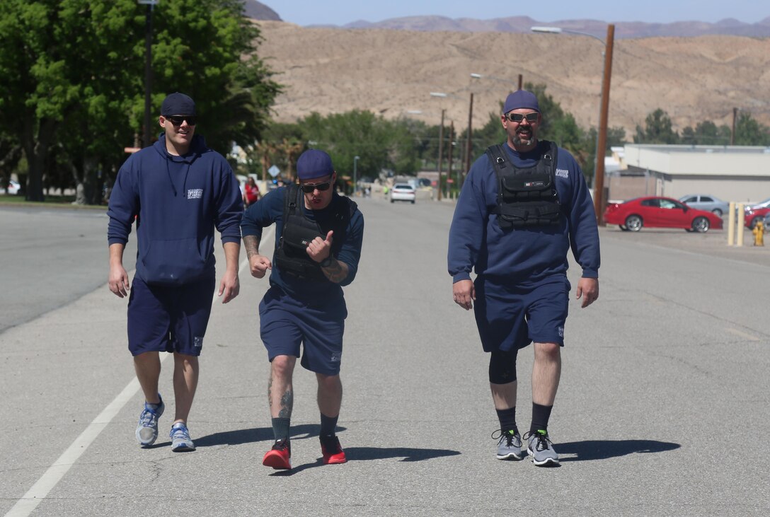 Shaun Longlee and David Pacileo, firefighters, work to keep up with Lt. Joseph Haresky, setting the bar high for Security and Emergency Services during the No More 5K aboard Marine Corps Logistics Base Barstow, Calif., April 15. The event drew awareness to domestic violence and sexual assault prevention. 