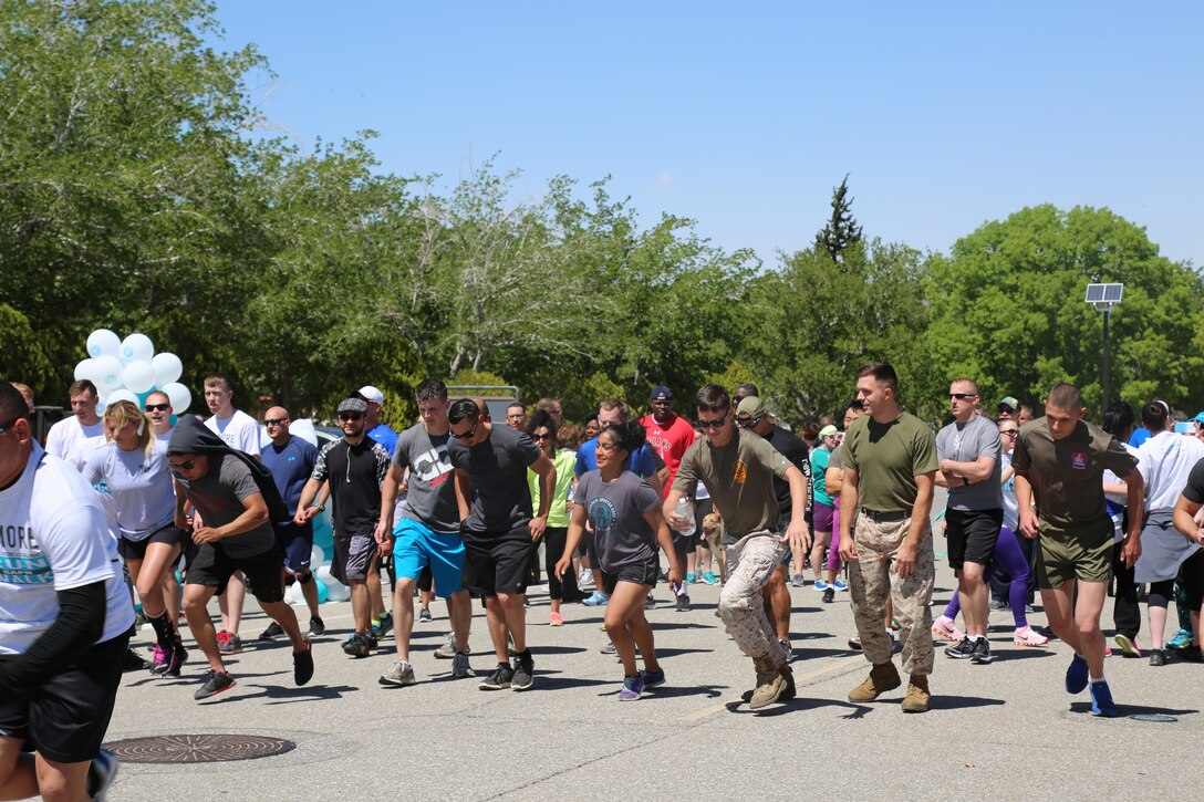 Marines and civilians kick off the No More 5K Walk/Run aboard Marine Corps Logistics Base Barstow, Calif.,  April 15. The 5K is intended to draw awareness to domestic violence and sexual assault prevention.  